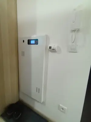 a small white refrigerator with a blue sticker on it at Lux studio sa saunom Ampelitsi in Ledine
