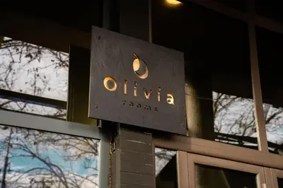 a sign on the side of a building at Olivia Rooms in Belgrade