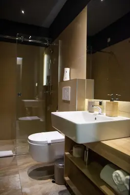 a bathroom with a white sink and a toilet at Olivia Rooms in Belgrade