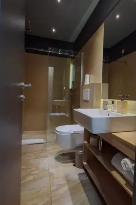 a bathroom with a toilet and a sink and a mirror at Olivia Rooms in Belgrade