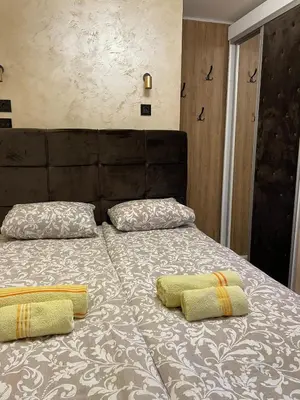 a bed with two pillows on top of it at Loronobeo.forest in Belgrade