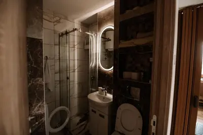 a small bathroom with a toilet and a sink at Loronobeo.forest in Belgrade