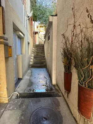 an alley with a drain in the middle of a building at Global City Studio in Belgrade