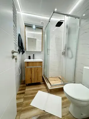 a bathroom with a shower and a toilet and a sink at Global City Studio in Belgrade
