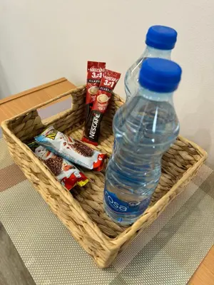 a basket with a bottle of water and some snacks at Global City Studio in Belgrade