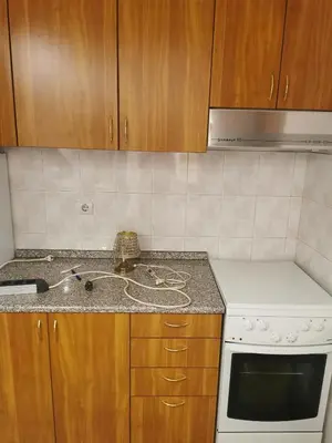 a kitchen with a stove and a counter top at Apartman Milica in Belgrade