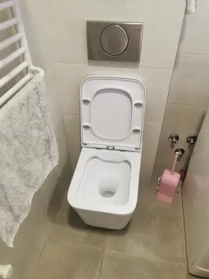 a small bathroom with a toilet with the lid up at Apartman Milica in Belgrade
