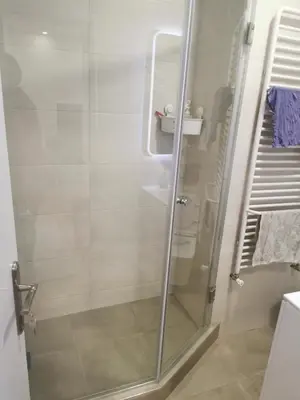a shower with a glass door in a bathroom at Apartman Milica in Belgrade