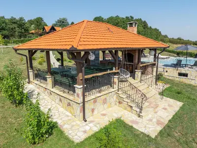 a gazebo with an orange roof in a yard at Ozoni & Spa in Sopot