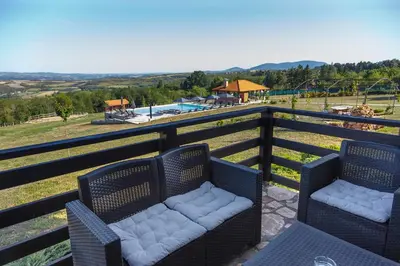 a balcony with two chairs and a view of a playground at Ozoni & Spa in Sopot