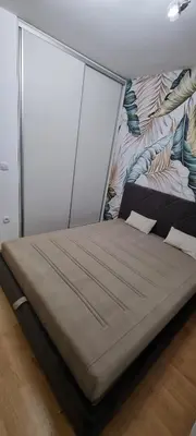a large bed in a room with a wall at Finans1 in Ruma
