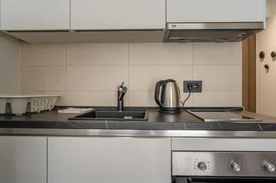a kitchen with a sink and a counter top at Kondina Suites in Belgrade