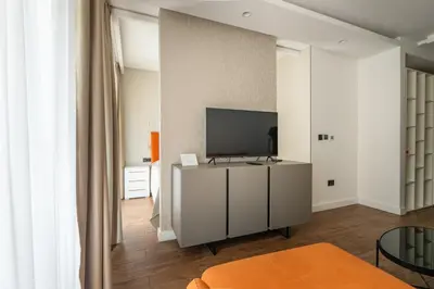 a living room with a flat screen tv on a wall at Kondina Suites in Belgrade
