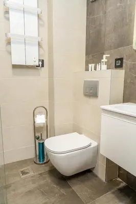 a bathroom with a toilet and a sink at Kondina Suites in Belgrade