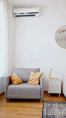 a living room with a couch and a air conditioner at Apartment SOFI Belville in Novi Beograd