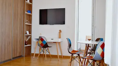 a living room with chairs and a table and a tv at Apartment SOFI Belville in Novi Beograd