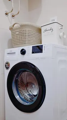 a washing machine with a basket on top of it at Apartment SOFI Belville in Novi Beograd