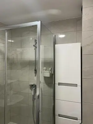 a shower with a glass door in a bathroom at Oaza Mirijevo in Mirijevo