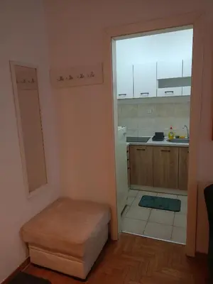 a kitchen with a large window and a stool in a room at Clockwork orange apartment in Vračar (historical)