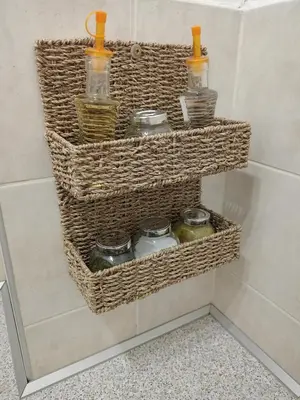 a bathroom with three baskets on the wall with jars at Clockwork orange apartment in Vračar (historical)