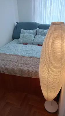 a bedroom with a bed with a lamp on it at Clockwork orange apartment in Vračar (historical)
