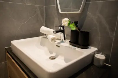 a bathroom sink with a white flower on it at Belgrade Simfonia - One bedroom apartment in Belgrade