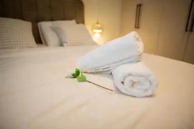 a rolled up towel on top of a bed at Belgrade Simfonia - One bedroom apartment in Belgrade