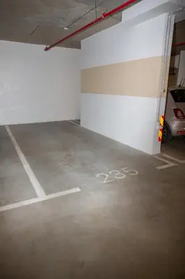 a parking garage with a bike painted on the floor at Belgrade Simfonia - One bedroom apartment in Belgrade