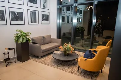 a living room with couches and a table and chairs at Belgrade Simfonia - One bedroom apartment in Belgrade