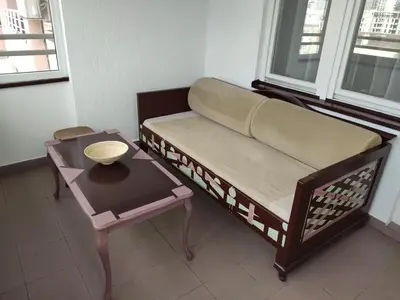 a couch and a table in a room with a window at Panorama 40 in Sajmište