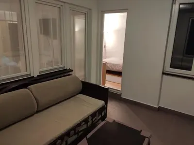 a living room with a couch and a window at Panorama 40 in Sajmište