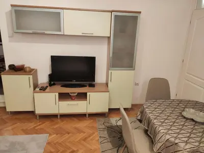 a bedroom with a bed and a tv on a desk at Panorama 40 in Sajmište