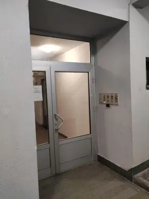 an open door in a building with a glass at Panorama 40 in Sajmište