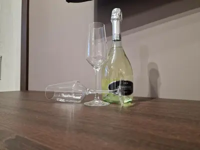 a bottle of wine and a glass on a table at Center Prestige Apartments in Belgrade