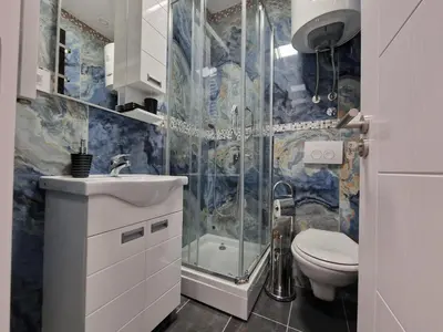 a bathroom with a shower and a toilet and a sink at Center Prestige Apartments in Belgrade
