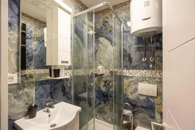 a bathroom with a sink and a shower at Center Prestige Apartments in Belgrade