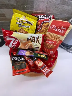 a basket of snacks and chips on a table at Surčin Centar apartment in Surčin