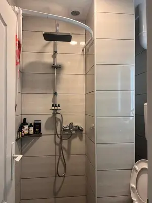 a bathroom with a shower with a toilet at Surčin Centar apartment in Surčin