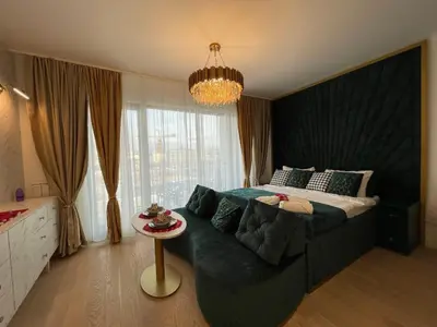 a bedroom with a large bed and a table at Beldorado Apartments - Belgrade Waterfront Luxury Apartment Amber in Belgrade