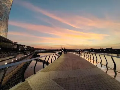 a bridge over a body of water with a sunset at Beldorado Apartments - Belgrade Waterfront Luxury Apartment Amber in Belgrade