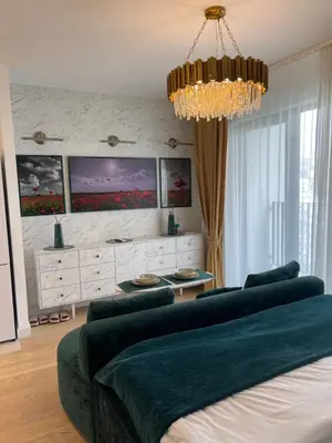a living room with a couch and a chandelier at Beldorado Apartments - Belgrade Waterfront Luxury Apartment Amber in Belgrade
