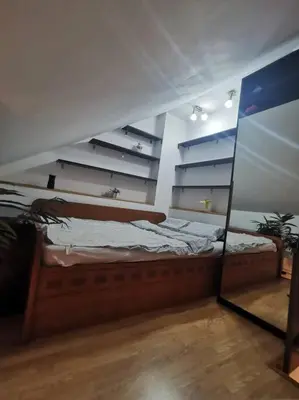a bedroom with a bed and a mirror at Knez Mihailova apartment - City Center in Belgrade