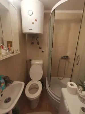a bathroom with a shower and a toilet and a sink at Knez Mihailova apartment - City Center in Belgrade