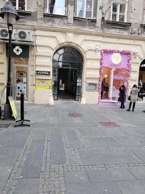 a building with a store front with a purple display at Knez Mihailova apartment - City Center in Belgrade