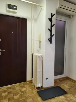 a room with a door and a rug next to a door at Breeze Apartment in Žarkovo