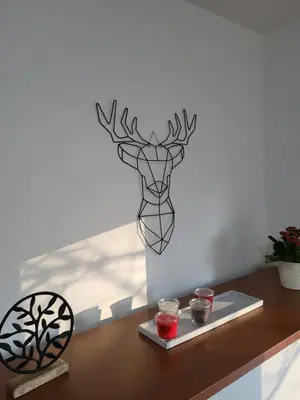 a wall art of a deer head on a wall at Breeze Apartment in Žarkovo