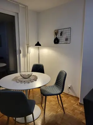 a white table and chairs in a living room at Breeze Apartment in Žarkovo