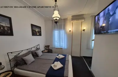 a bedroom with a bed and a flat screen tv at Authentic Belgrade Centre Apartments for large groups, Republic Square - Up to 47 People in 5 Apartments in Belgrade
