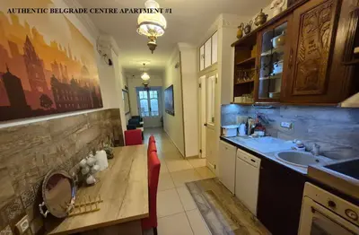a kitchen with a sink and a wooden table at Authentic Belgrade Centre Apartments for large groups, Republic Square - Up to 47 People in 5 Apartments in Belgrade