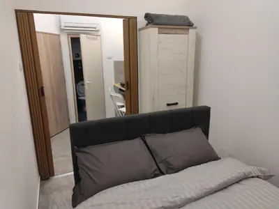 a couch with a pillow in front of a mirror at The nest in Dušanovac (historical)